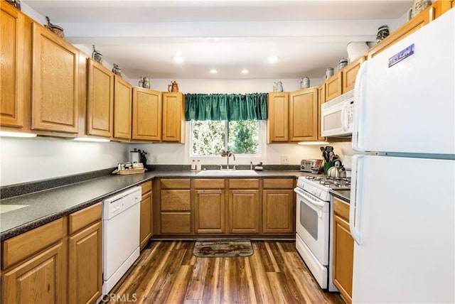 kitchen with sink, white appliances, and dark hardwood / wood-style flooring