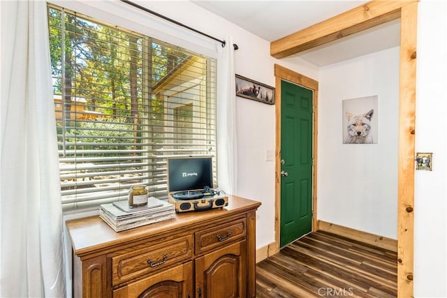 office featuring dark hardwood / wood-style flooring and beamed ceiling