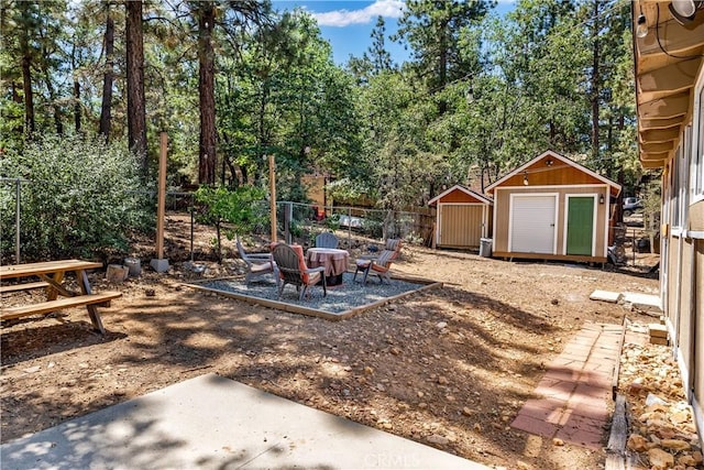 view of yard featuring a storage shed and a fire pit