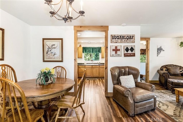 dining room featuring a chandelier, wood-type flooring, and sink