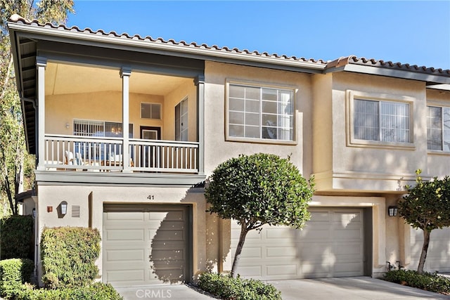 view of front facade with a balcony and a garage