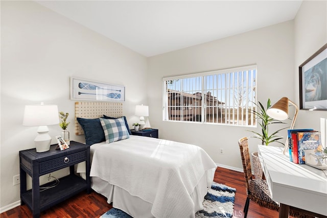 bedroom with dark hardwood / wood-style floors