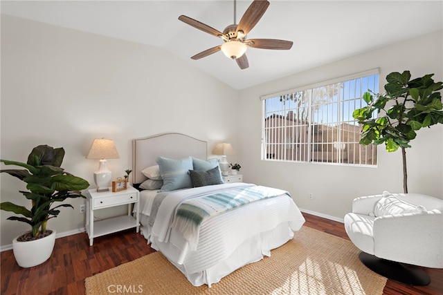 bedroom with ceiling fan, dark hardwood / wood-style flooring, and lofted ceiling