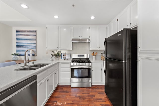 kitchen with dark wood-type flooring, sink, white cabinets, and appliances with stainless steel finishes