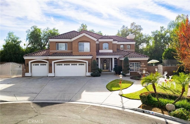 mediterranean / spanish home featuring a garage