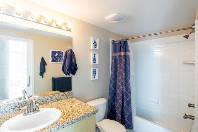 full bathroom featuring toilet, shower / bath combination with curtain, and vanity