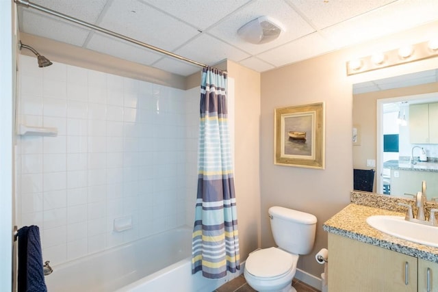 full bathroom featuring toilet, a paneled ceiling, shower / bath combo, and vanity