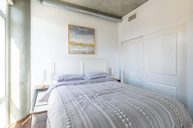 bedroom with a closet and dark wood-type flooring