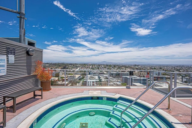 view of pool with a hot tub