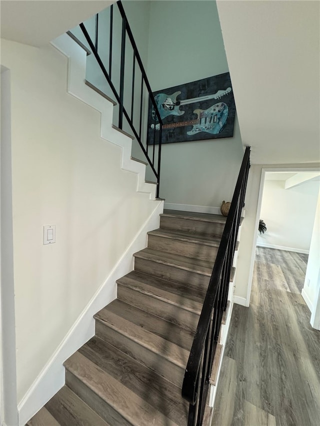 stairs featuring hardwood / wood-style floors