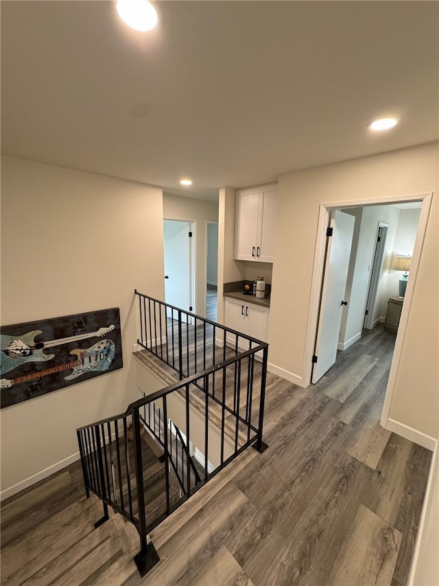 stairs featuring hardwood / wood-style floors