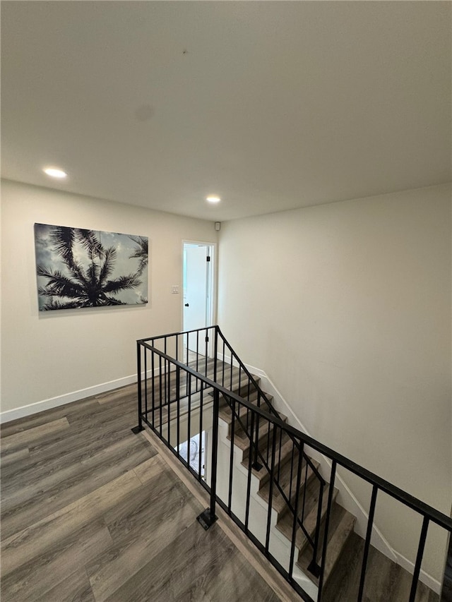 stairway featuring hardwood / wood-style flooring