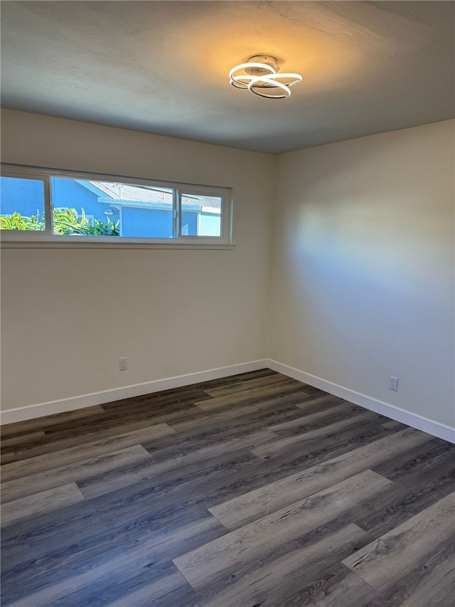 unfurnished room featuring dark hardwood / wood-style floors