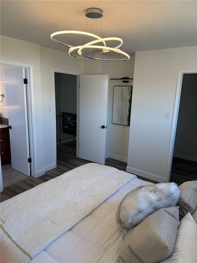 bedroom featuring a chandelier and dark hardwood / wood-style flooring