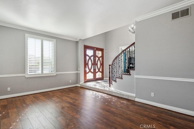 entryway with crown molding, an inviting chandelier, french doors, and dark hardwood / wood-style flooring