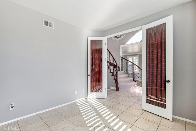 foyer entrance featuring a notable chandelier and light tile patterned floors