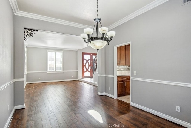 interior space with hardwood / wood-style floors, french doors, a chandelier, and ornamental molding