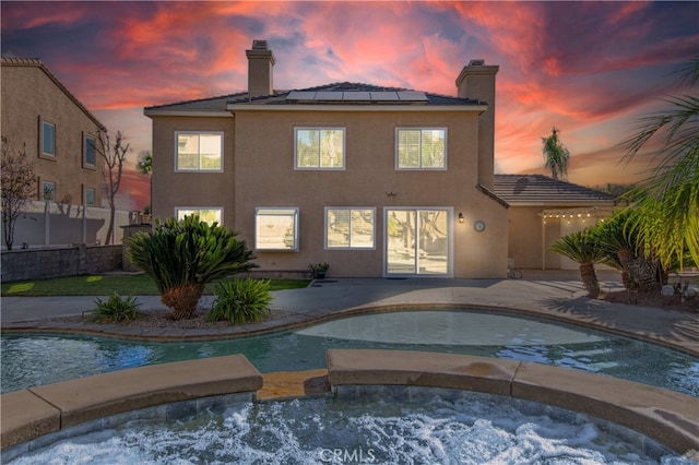 view of pool at dusk