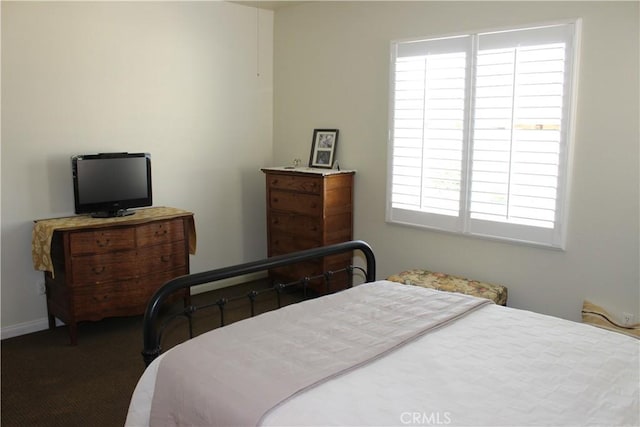 carpeted bedroom featuring multiple windows