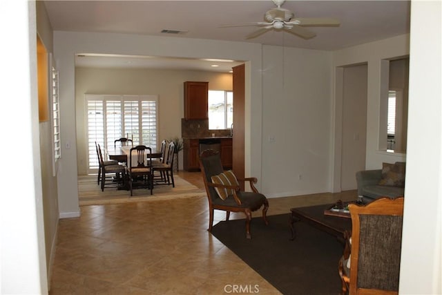 interior space with ceiling fan