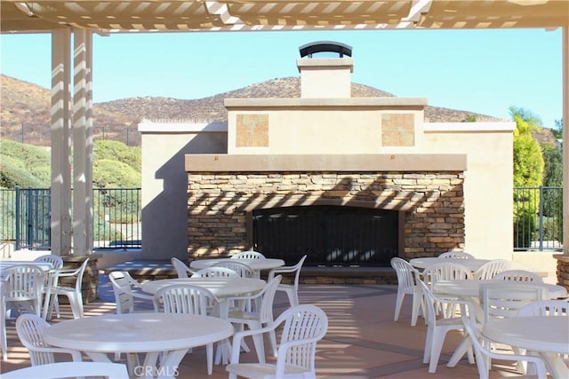 view of patio with a pergola and a mountain view