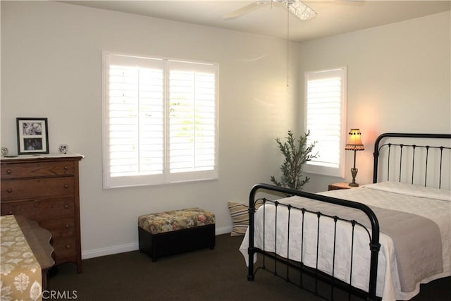 bedroom with ceiling fan and multiple windows