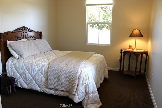 bedroom featuring dark carpet