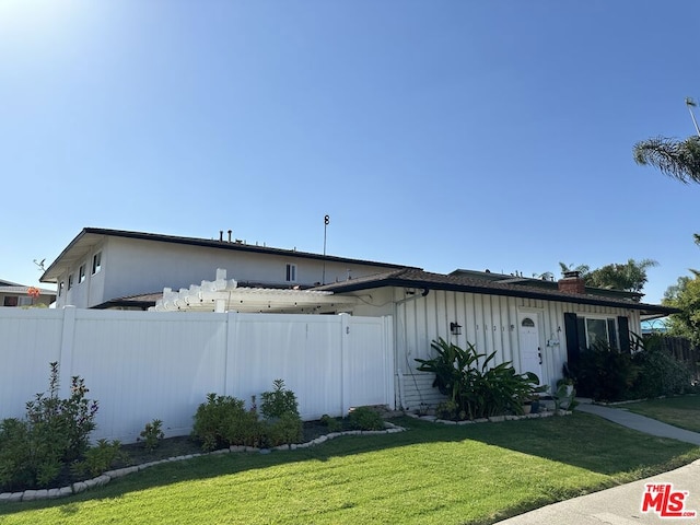 view of side of home featuring a lawn