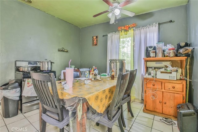 dining space featuring light tile patterned floors and a ceiling fan