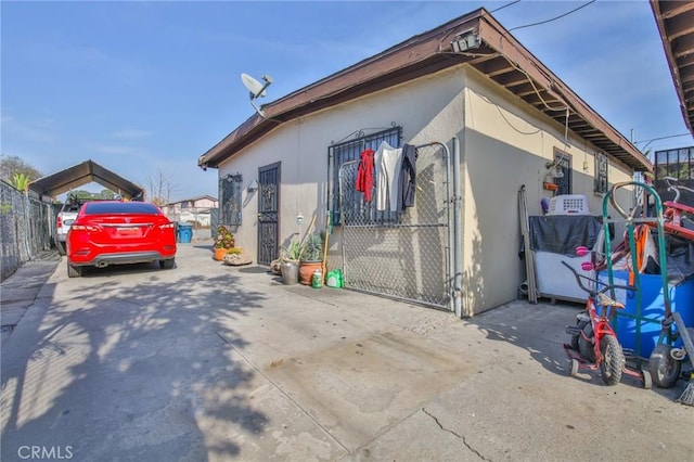 view of home's exterior with fence and stucco siding