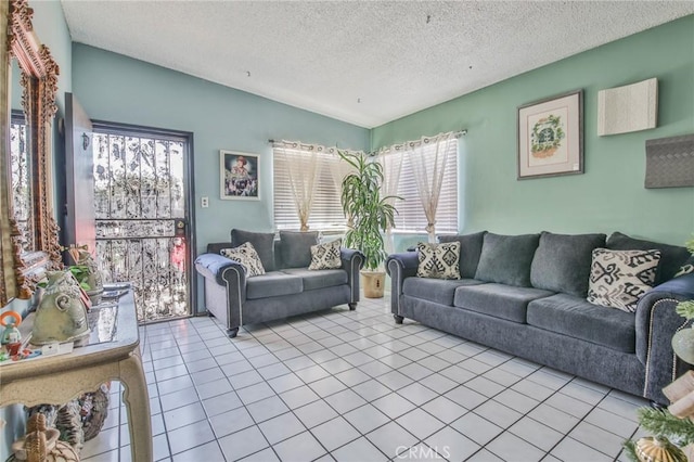 living area featuring tile patterned flooring and a textured ceiling