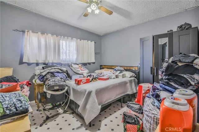 bedroom featuring lofted ceiling, ceiling fan, and a textured ceiling