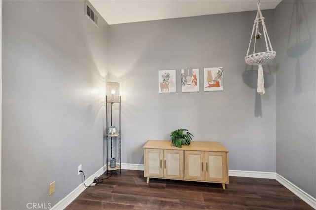 interior space featuring visible vents, baseboards, and wood finished floors