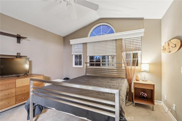 bedroom with lofted ceiling, baseboards, a ceiling fan, and light colored carpet