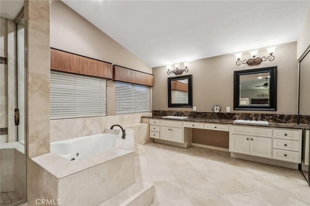 full bath with lofted ceiling, a sink, a jetted tub, and double vanity