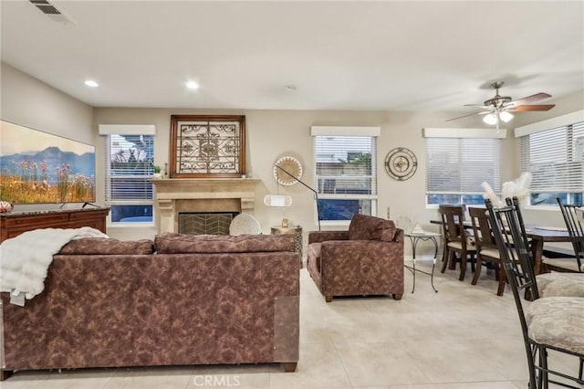 living area featuring a fireplace, recessed lighting, visible vents, a ceiling fan, and baseboards