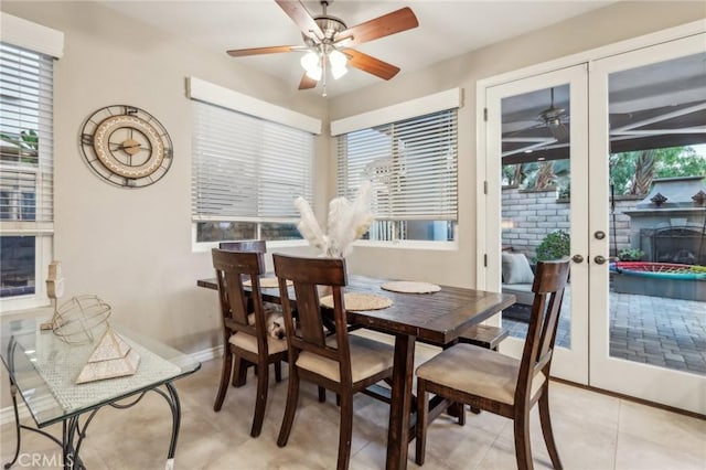 dining room with light tile patterned floors, ceiling fan, baseboards, and french doors