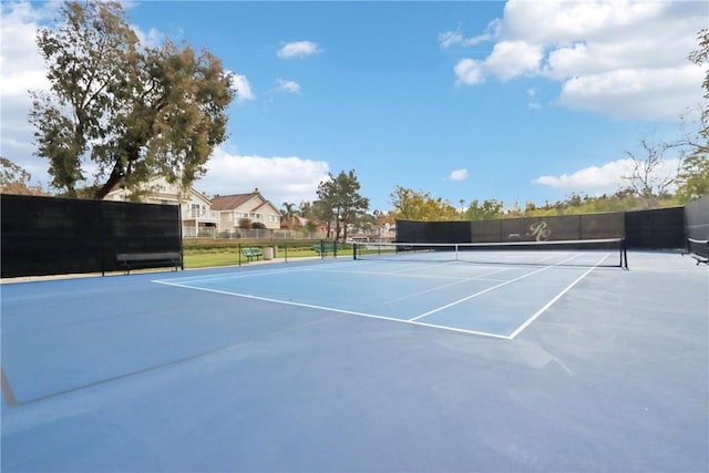 view of tennis court with fence