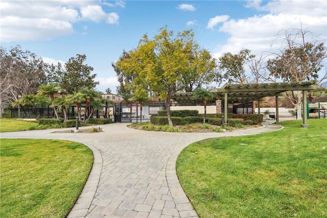 view of property's community featuring a yard, fence, and a pergola