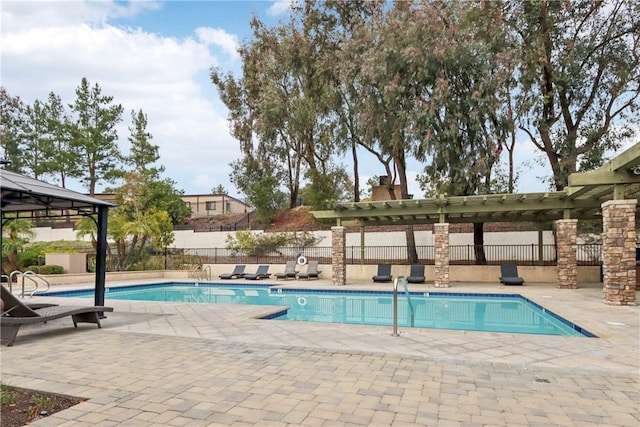 pool with a patio area, fence, a gazebo, and a pergola