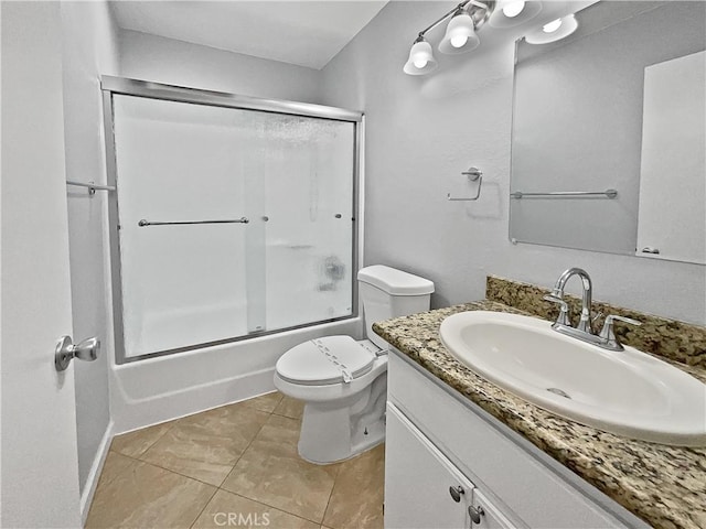 full bathroom featuring toilet, bath / shower combo with glass door, tile patterned flooring, and vanity