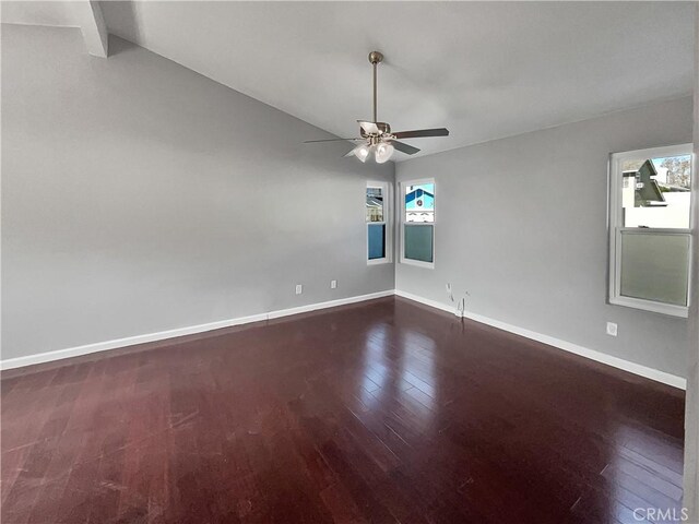 empty room featuring ceiling fan, dark hardwood / wood-style flooring, and a wealth of natural light