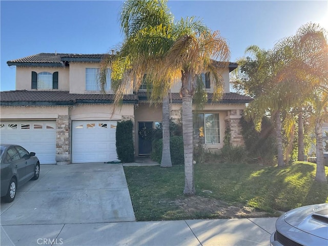 mediterranean / spanish-style home with a garage and a front lawn