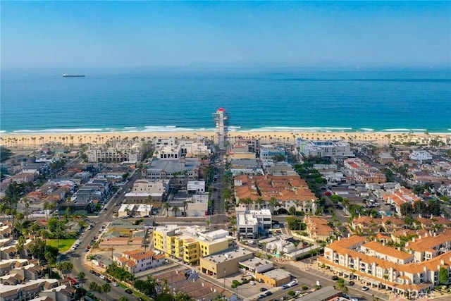 birds eye view of property with a water view and a view of the beach