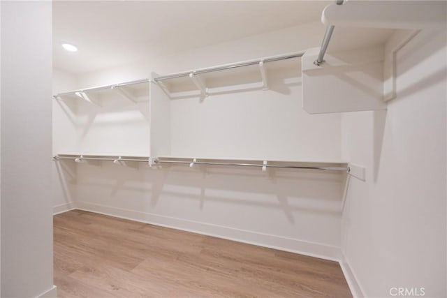 walk in closet featuring hardwood / wood-style floors