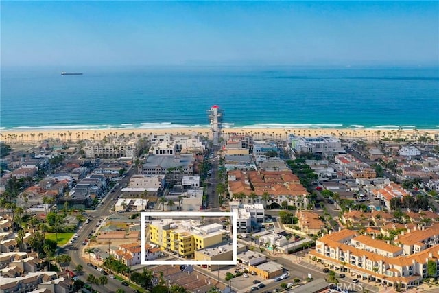 bird's eye view featuring a view of the beach and a water view