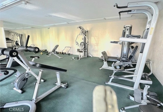 exercise room featuring a textured ceiling