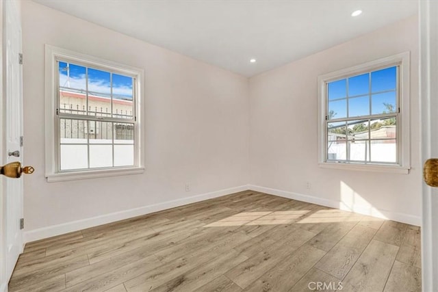 spare room featuring light hardwood / wood-style floors