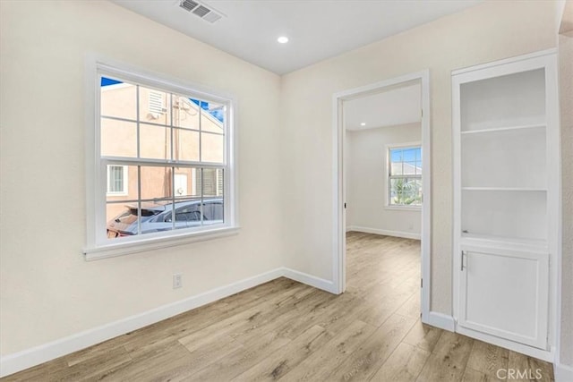 unfurnished room with light hardwood / wood-style floors