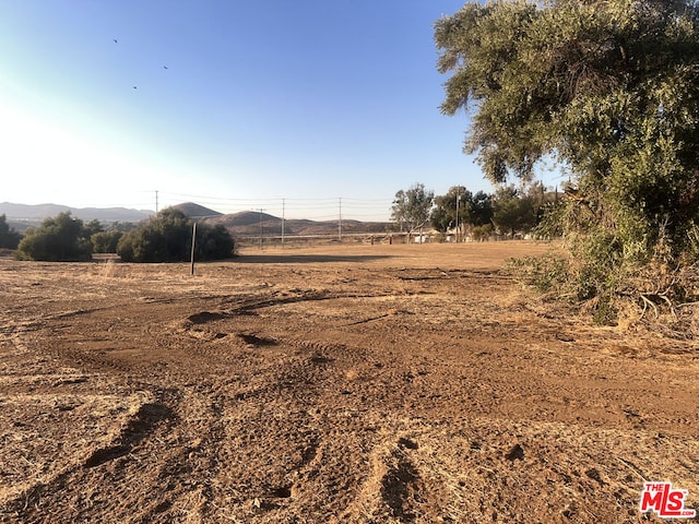 view of yard featuring a rural view and a mountain view